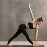 girl practice yoga with the help of yoga blocks